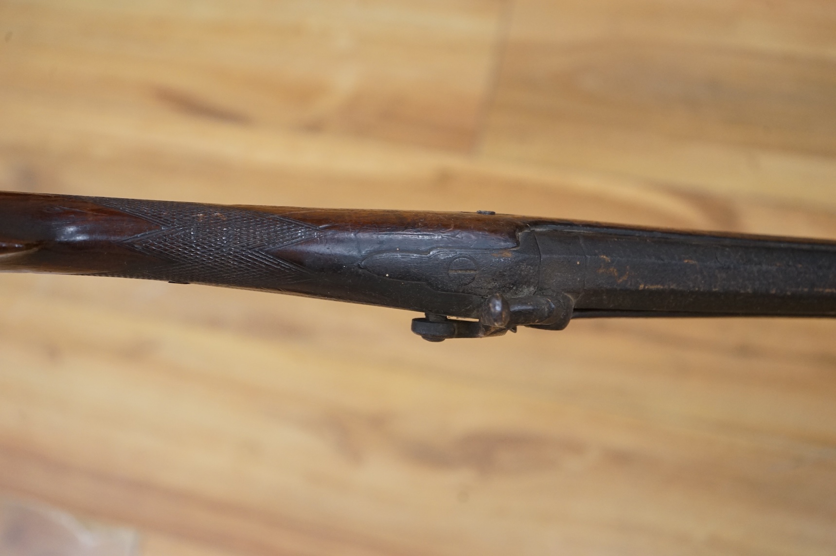 An English 16 bore back action, single barrel, percussion sporting gun, with half octagonal barrel half-stocked, barrel 82cm, iron mounted, chequered grip and fore end